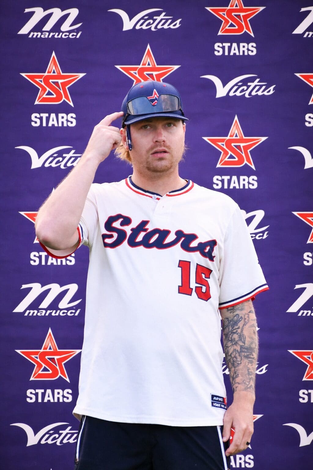 Baseball player at a branded backdrop